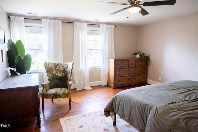 bedroom with light hardwood / wood-style flooring and ceiling fan