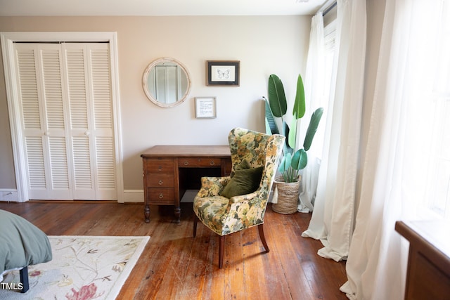 living area featuring a wealth of natural light and dark hardwood / wood-style floors