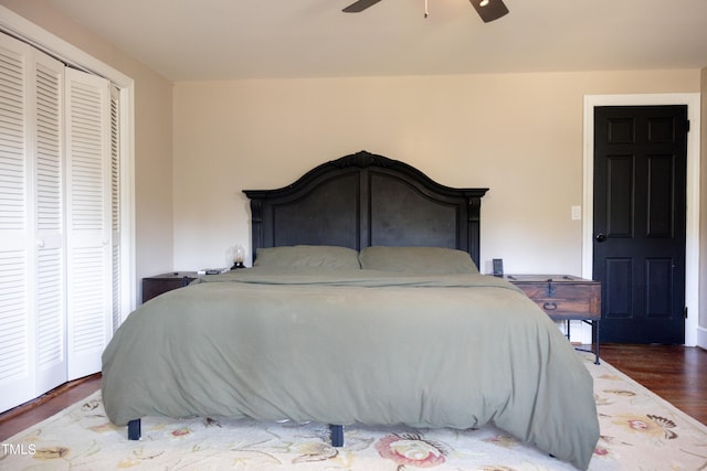 bedroom featuring ceiling fan, a closet, and dark hardwood / wood-style flooring