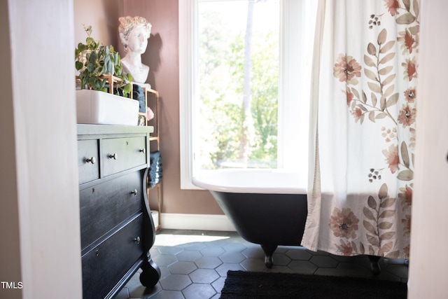 interior space featuring tile patterned flooring and a bathing tub