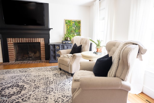 living room featuring hardwood / wood-style flooring and a fireplace