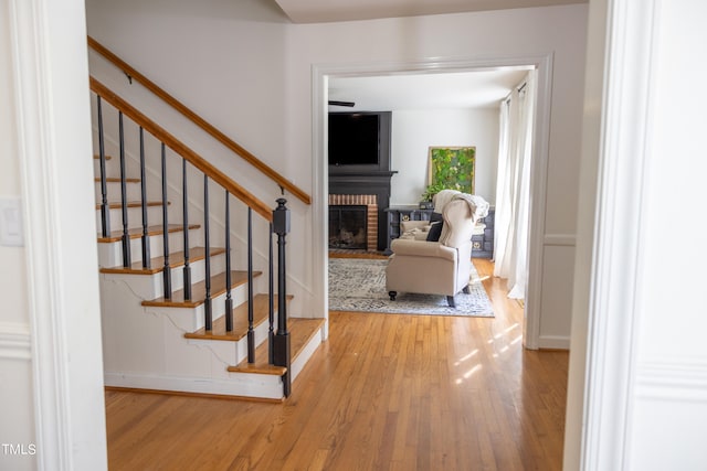 interior space with light hardwood / wood-style flooring and a brick fireplace