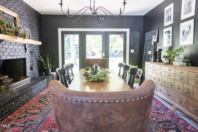 dining room with a fireplace and a notable chandelier