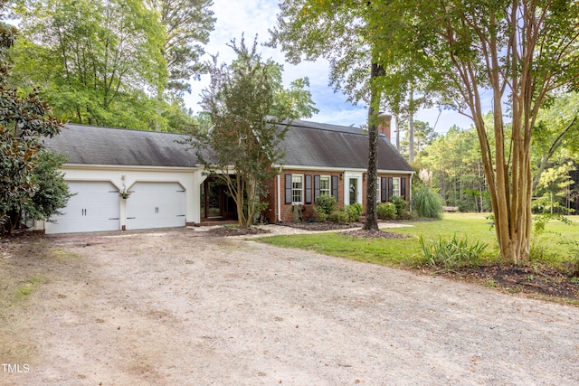 view of front of home with a garage and a front yard