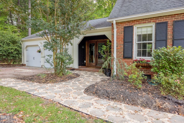 doorway to property with a garage