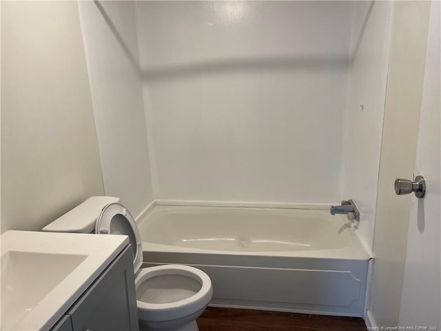 bathroom featuring wood-type flooring, vanity, and toilet