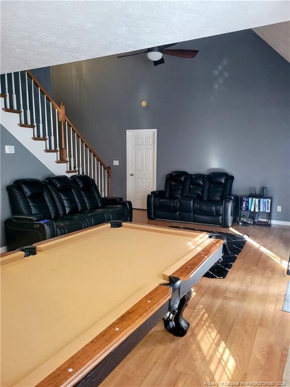 rec room featuring a textured ceiling and hardwood / wood-style floors