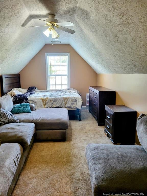 carpeted bedroom featuring a textured ceiling, ceiling fan, and vaulted ceiling