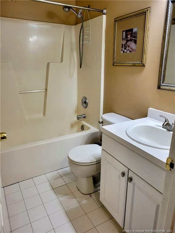 full bathroom featuring tile patterned flooring, toilet, shower / washtub combination, and vanity