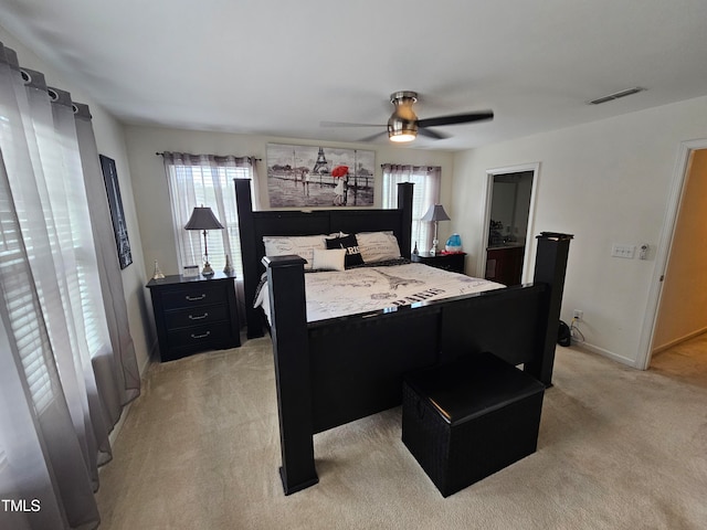 bedroom featuring light colored carpet and ceiling fan