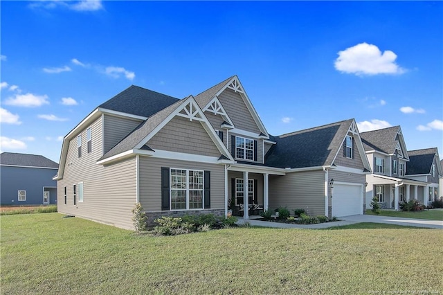 craftsman inspired home with a garage and a front lawn