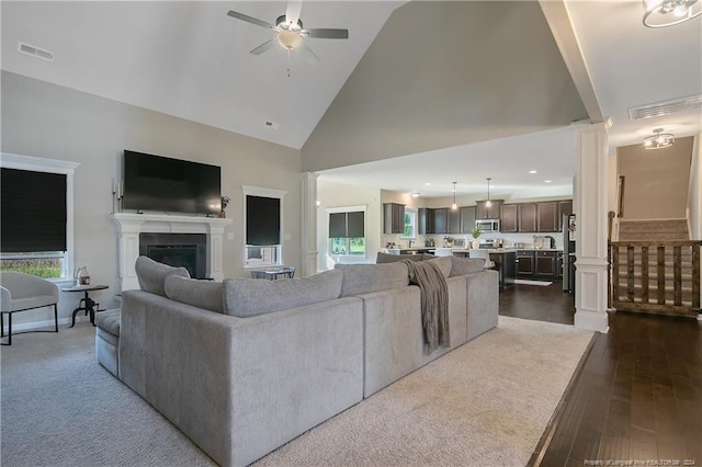 living room featuring high vaulted ceiling, ceiling fan, and dark hardwood / wood-style flooring