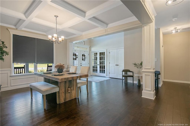 dining room with dark wood-type flooring, coffered ceiling, and decorative columns