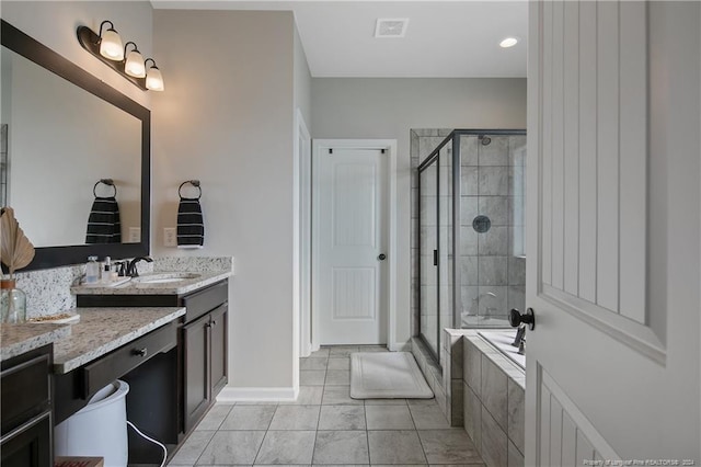 bathroom with tile patterned flooring, vanity, and separate shower and tub