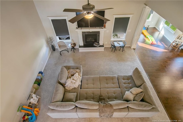 living room with ceiling fan and wood-type flooring