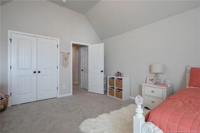 bedroom with a closet, high vaulted ceiling, and light carpet