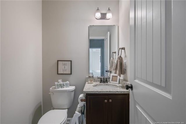 bathroom with toilet and vanity