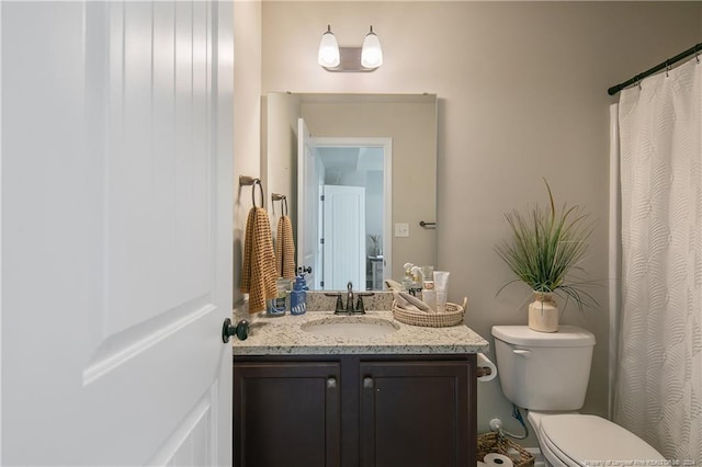 bathroom with toilet and vanity