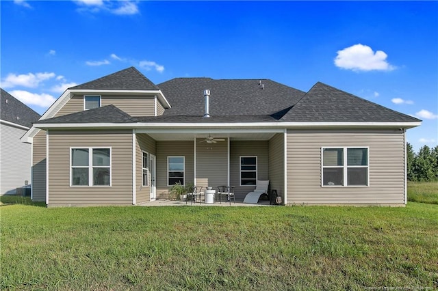 back of property with a patio area, a yard, and ceiling fan