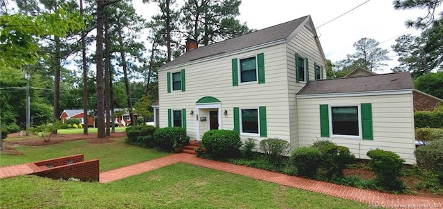 colonial-style house with a front lawn