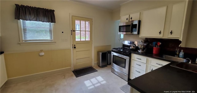 kitchen featuring sink, white cabinets, and stainless steel appliances