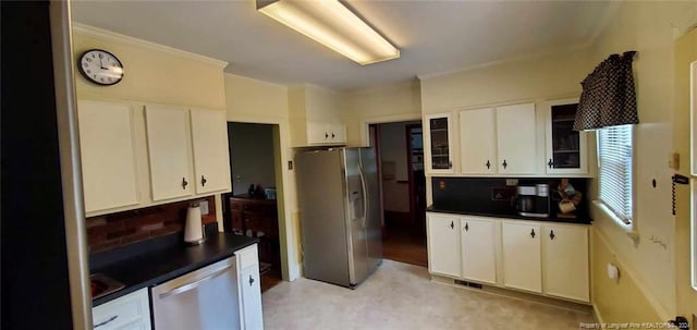 kitchen featuring white cabinets, stainless steel appliances, and tasteful backsplash