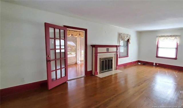 unfurnished living room with wood-type flooring