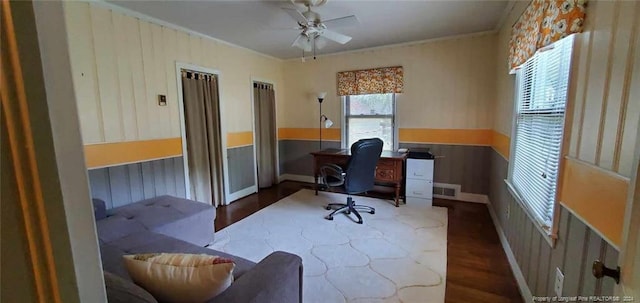 office space with ornamental molding, ceiling fan, and dark wood-type flooring