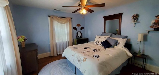 bedroom with ceiling fan and dark wood-type flooring