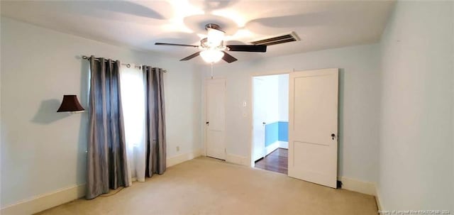 carpeted empty room with ceiling fan