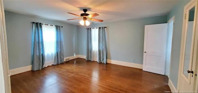 unfurnished room with dark hardwood / wood-style floors and ceiling fan