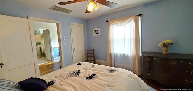 bedroom featuring ceiling fan, hardwood / wood-style floors, and ensuite bathroom