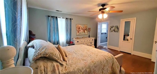 bedroom with ceiling fan and dark wood-type flooring