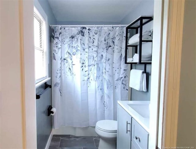 bathroom with vanity, toilet, and tile patterned floors