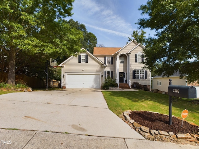 front facade featuring a garage and a front yard