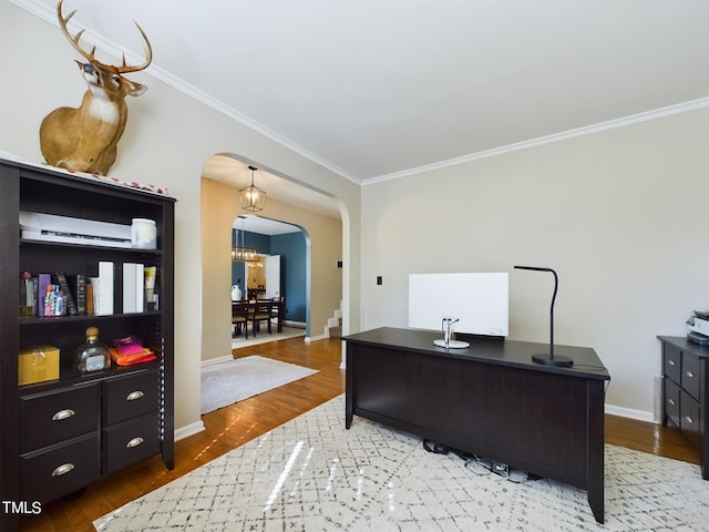 home office with wood-type flooring, an inviting chandelier, and crown molding