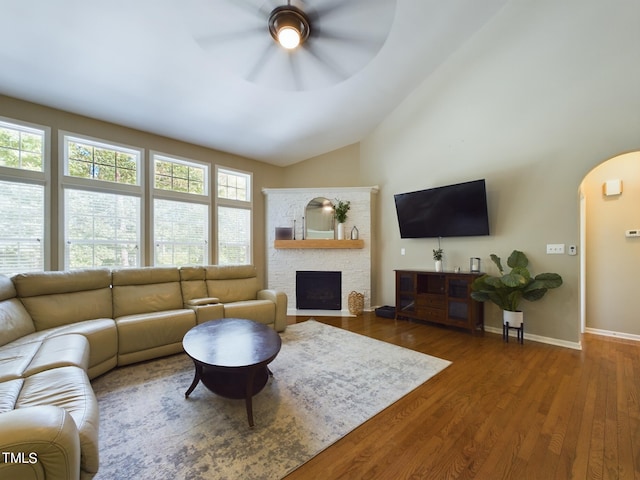 living room featuring lofted ceiling, ceiling fan, and dark hardwood / wood-style floors