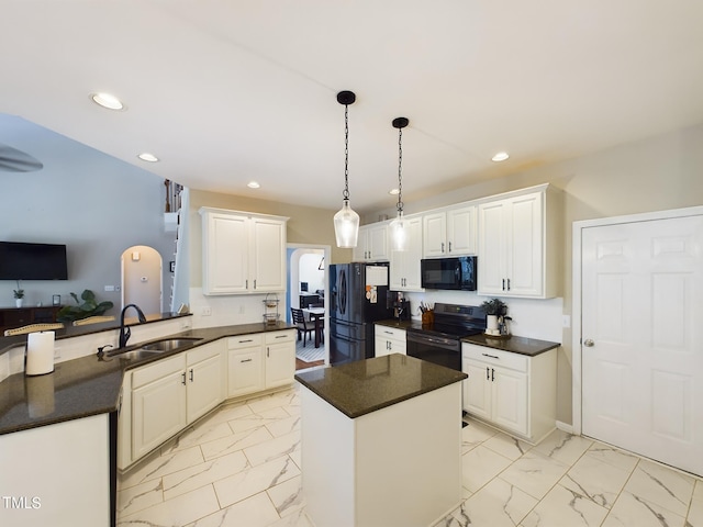 kitchen featuring decorative light fixtures, black appliances, kitchen peninsula, sink, and white cabinets