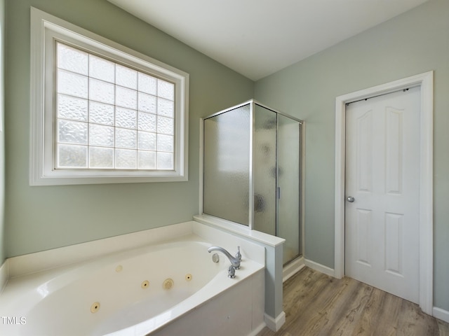 bathroom featuring hardwood / wood-style floors and independent shower and bath