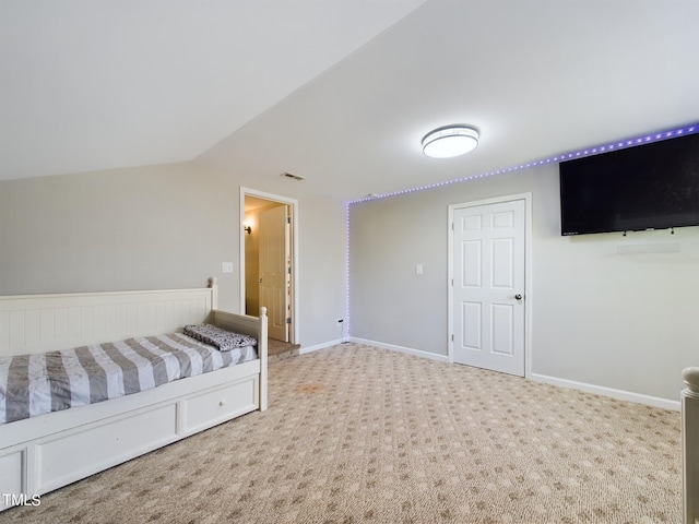 unfurnished bedroom with carpet and vaulted ceiling