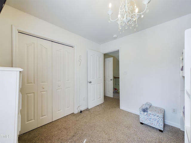 carpeted bedroom with an inviting chandelier and a closet