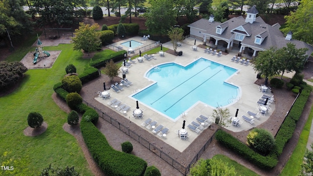 view of pool with a yard and a patio