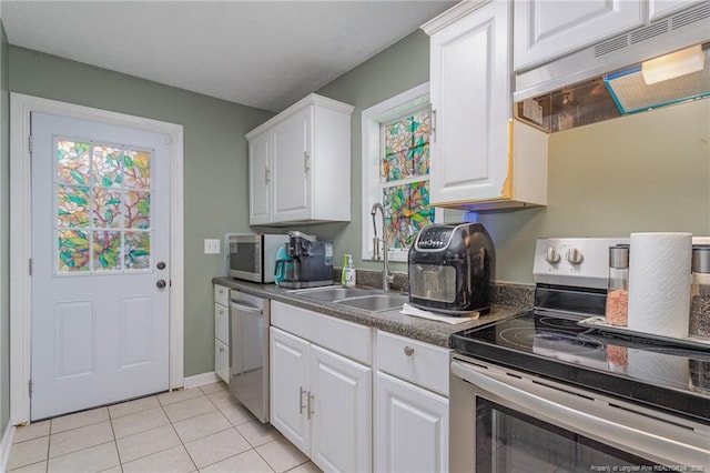 kitchen featuring white cabinetry, stainless steel appliances, light tile patterned flooring, and sink