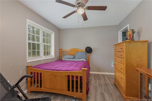 bedroom featuring wood-type flooring and ceiling fan