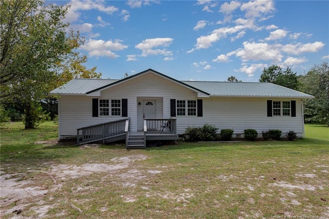 view of front facade with metal roof and a front yard