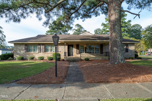 single story home featuring a porch and a front yard