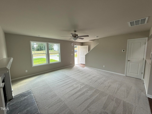 unfurnished living room with ceiling fan and light colored carpet