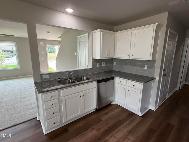 kitchen featuring dishwasher, dark wood-type flooring, sink, white cabinetry, and backsplash