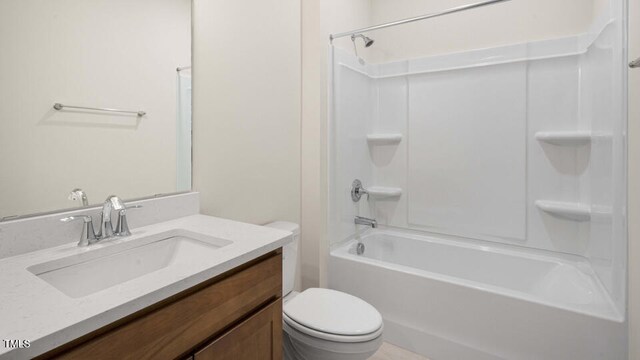 full bathroom with vanity, washtub / shower combination, and toilet