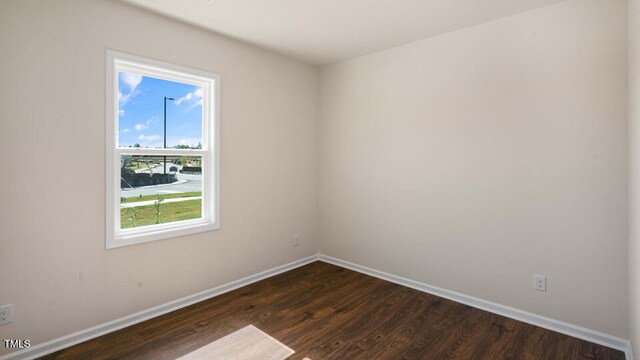 spare room with dark hardwood / wood-style flooring